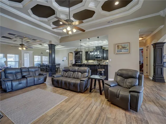 a living room with furniture and a chandelier