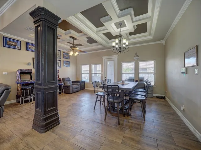 a view of a dining room with furniture and chandelier
