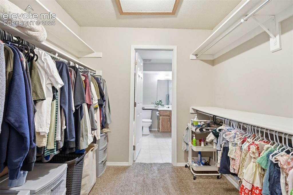 4357 Hunting Meadows Circle Colorado Springs, CO 80916 - Photo 10 of 20 a view of walk in closet with clothes and shoes