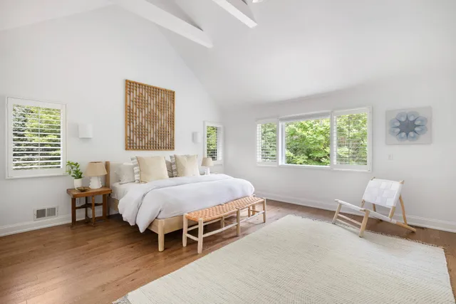 a bedroom with a bed and a large window