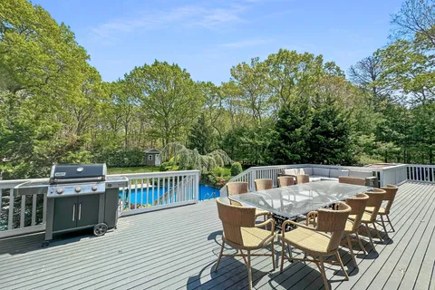 a view of a dinning table and chairs on the roof deck