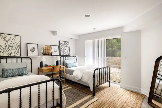 a bedroom with furniture and a window