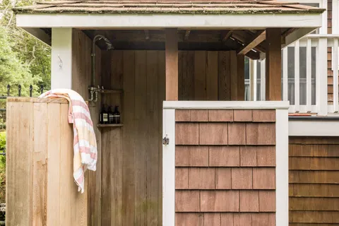 an aerial view of a house with a yard and lake view