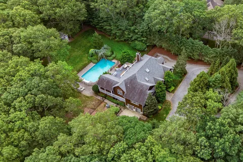 an aerial view of a house with a yard