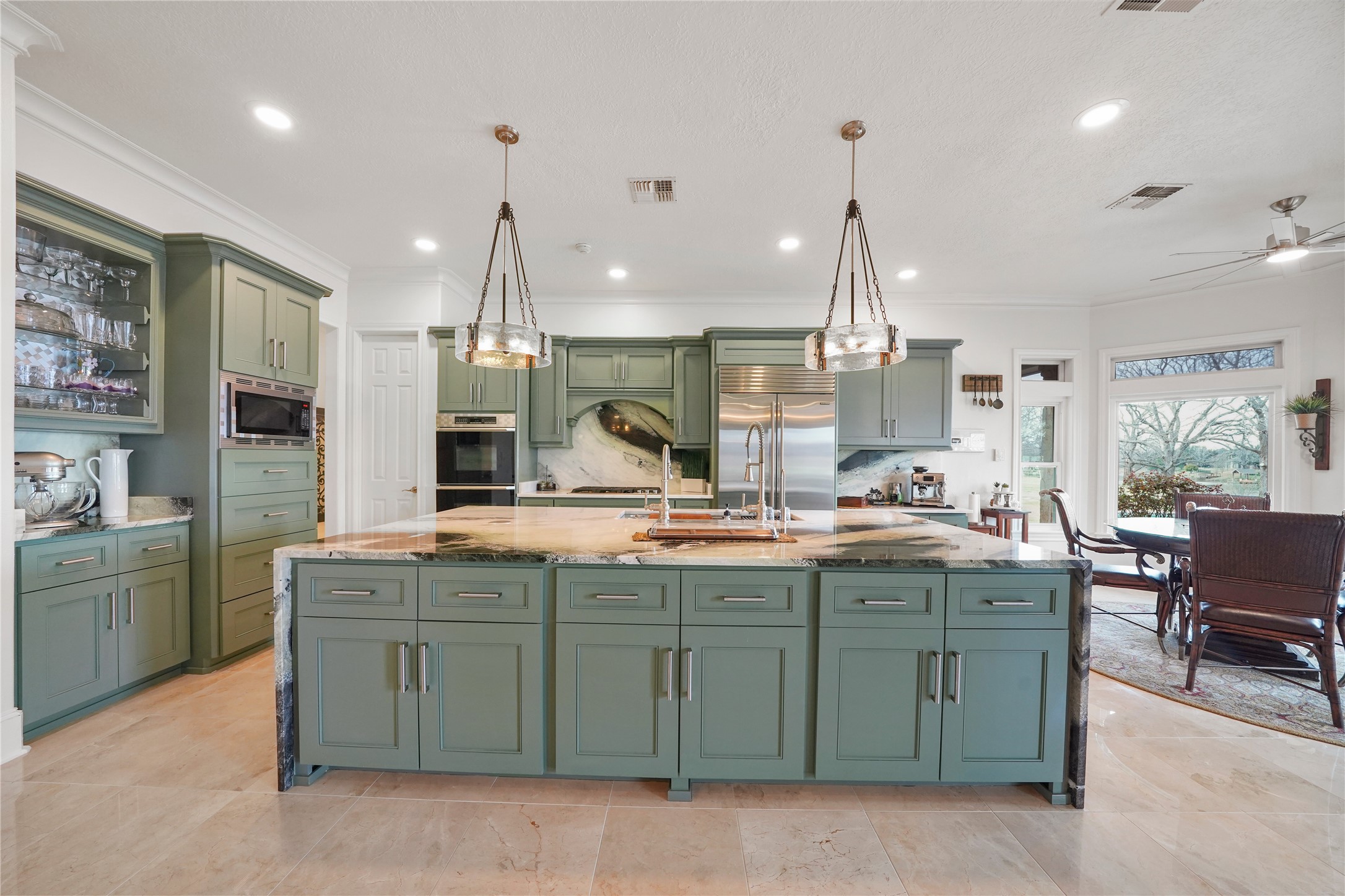 32134 Fulbrook Commons Fulshear, TX 77441 - Photo 11 of 49 Expansive cabinetry, premium finishes, and refined design details elevate the kitchen into a sophisticated culinary space anchored by a statement island.