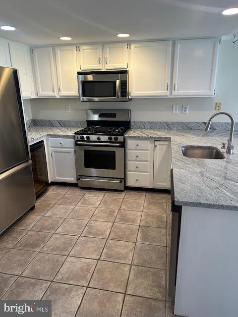 23 Bogey Circle Doylestown, PA 18901 - Photo 2 of 32 a kitchen with granite countertop a stove a sink and a microwave