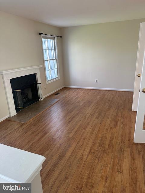23 Bogey Circle Doylestown, PA 18901 - Photo 5 of 32 an empty room with wooden floor fireplace and windows