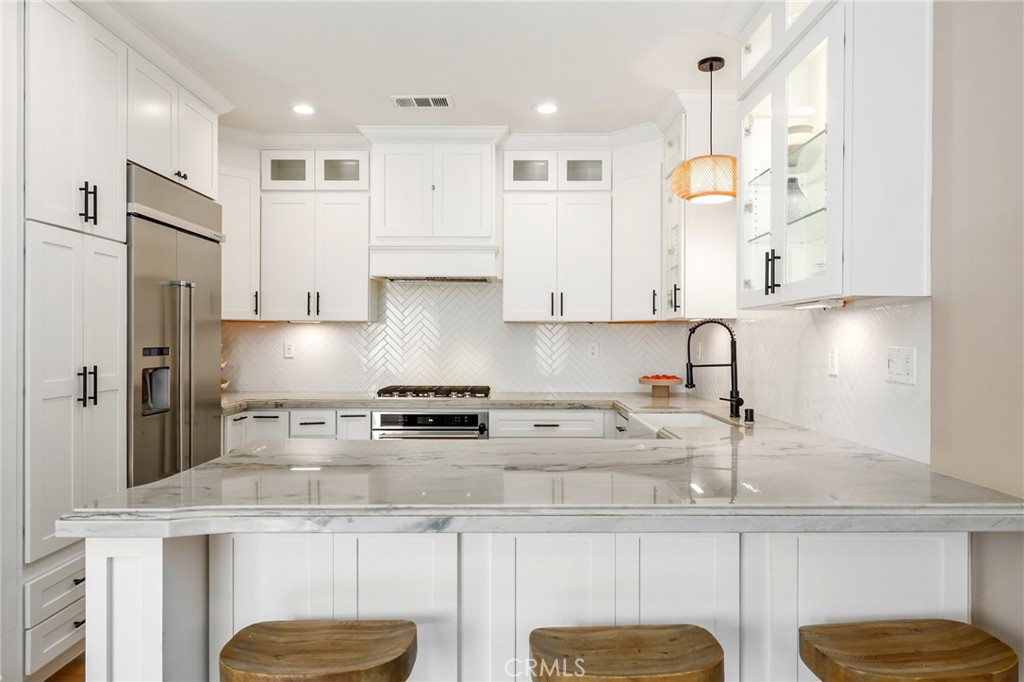 217 Sklar Street Ladera Ranch, CA 92694 - Photo 21 of 59 a kitchen with stainless steel appliances granite countertop a sink a stove and a refrigerator