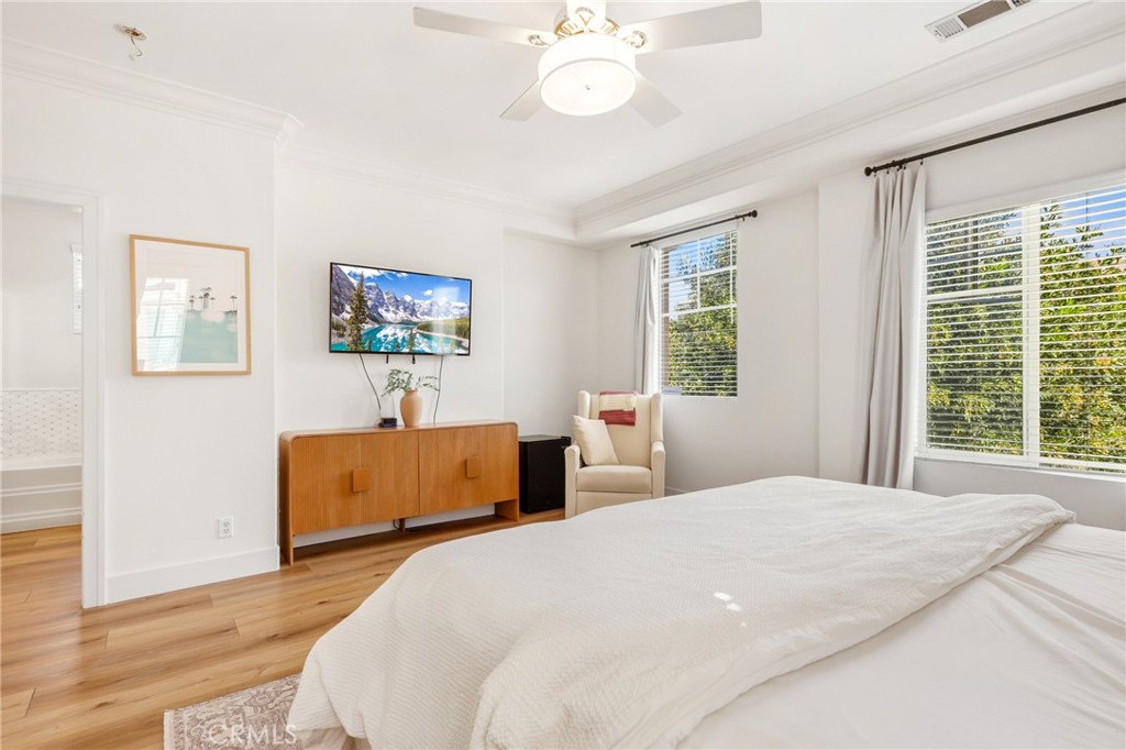 217 Sklar Street Ladera Ranch, CA 92694 - Photo 24 of 59 a bedroom with a large bed a chandelier and a window