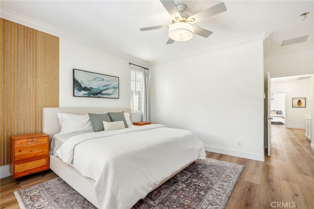 217 Sklar Street Ladera Ranch, CA 92694 - Photo 25 of 59 a bedroom with a large bed and a chandelier