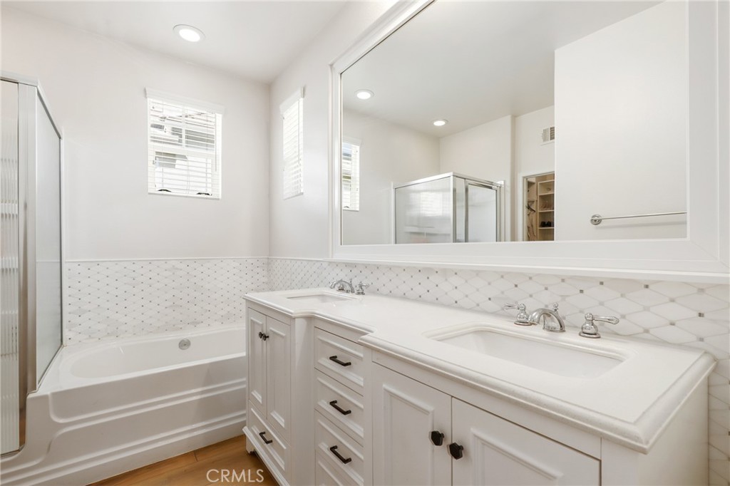217 Sklar Street Ladera Ranch, CA 92694 - Photo 31 of 59 a bathroom with a sink double vanity granite tub shower and a mirror