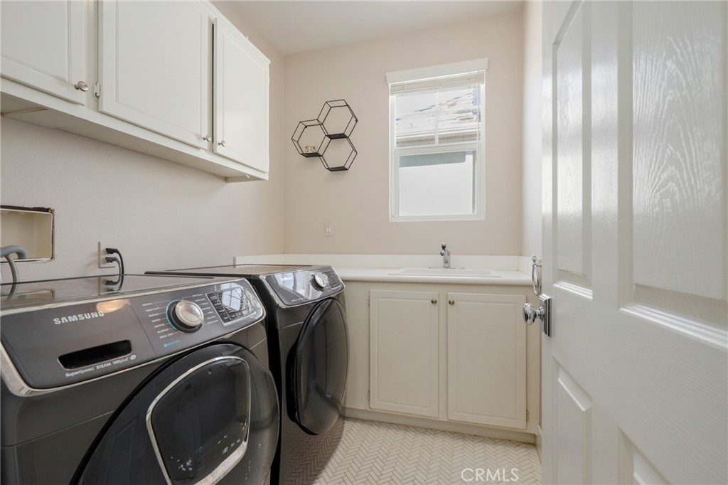 217 Sklar Street Ladera Ranch, CA 92694 - Photo 35 of 59 a utility room with cabinets dryer and washer