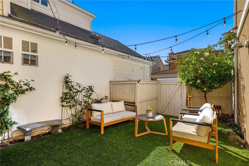 217 Sklar Street Ladera Ranch, CA 92694 - Photo 38 of 59 a view of a white house with a big yard and a patio