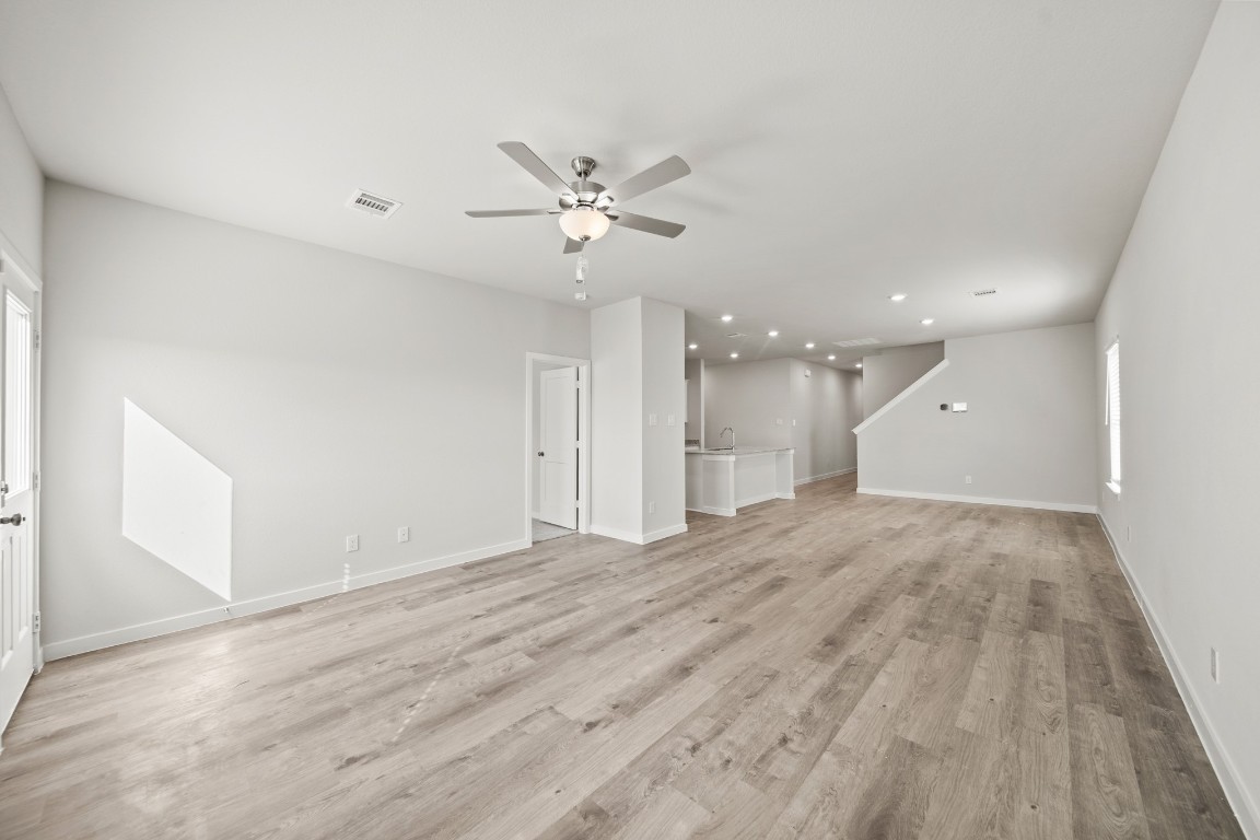 314 Amy Street Angleton, TX 77515 - Photo 13 of 31 a view of an empty room with a ceiling fan