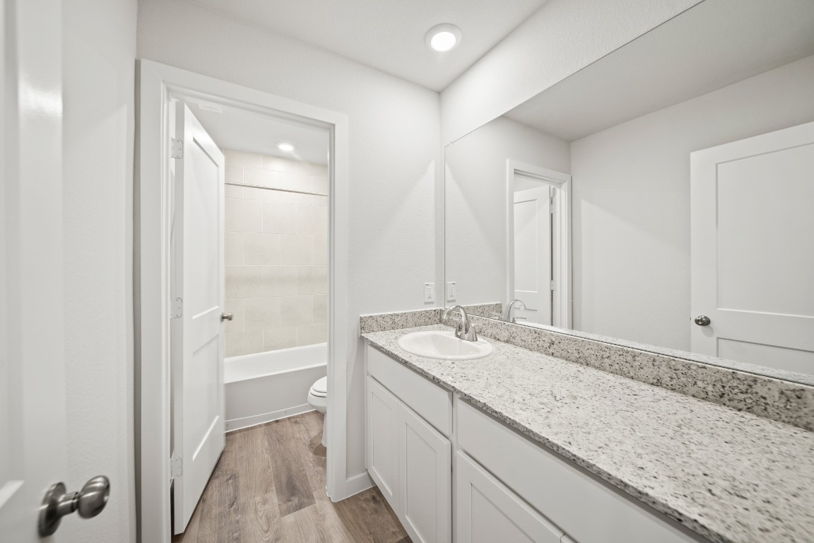 314 Amy Street Angleton, TX 77515 - Photo 23 of 31 a bathroom with a granite countertop sink and a mirror