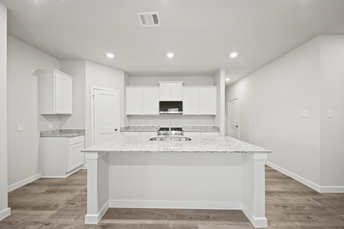 314 Amy Street Angleton, TX 77515 - Photo 8 of 31 a view of kitchen with sink stove and refrigerator