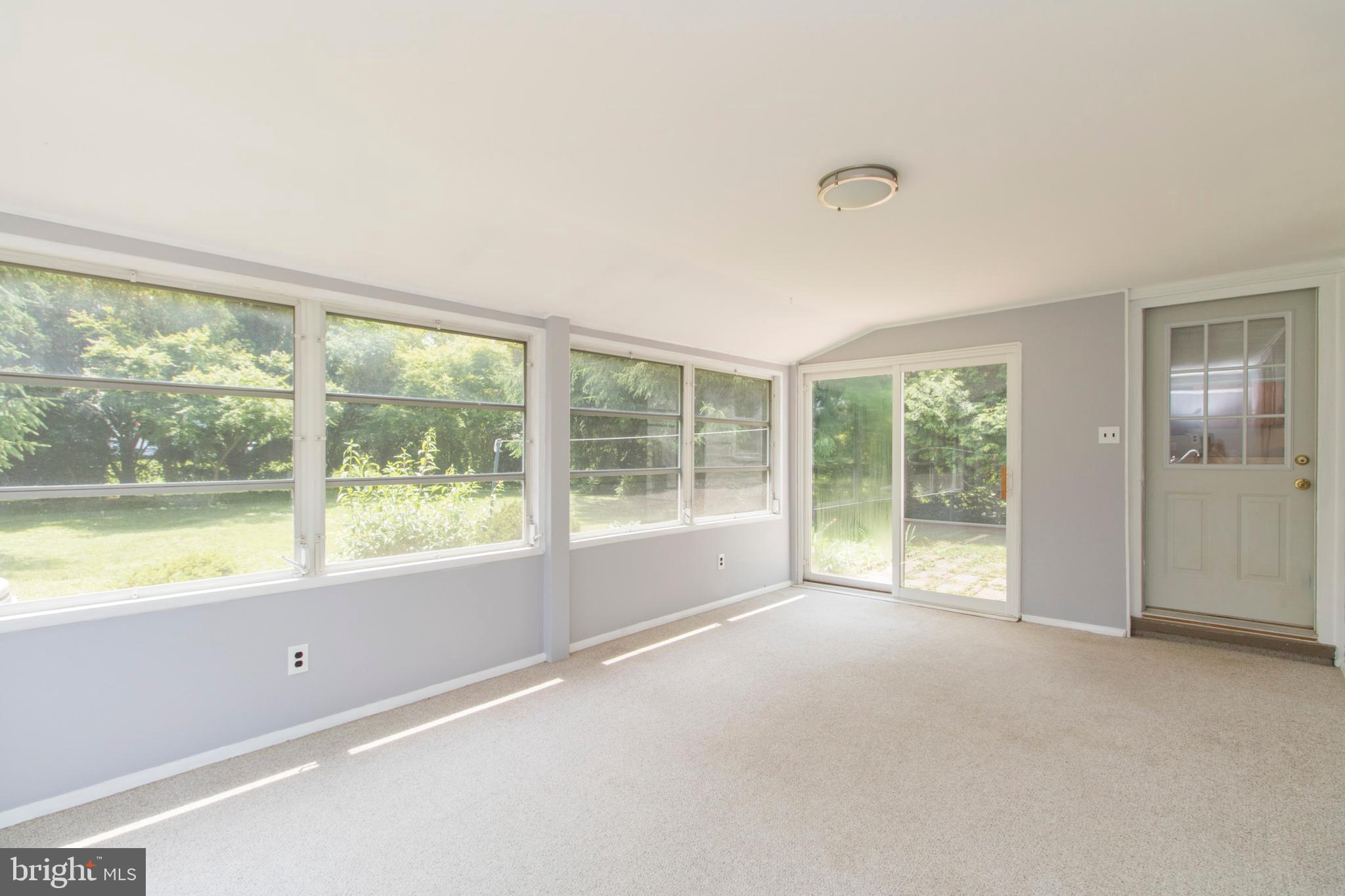 406 Burton Road Oreland, PA 19075 - Photo 17 of 44 Enclosed porch with slider to backyard