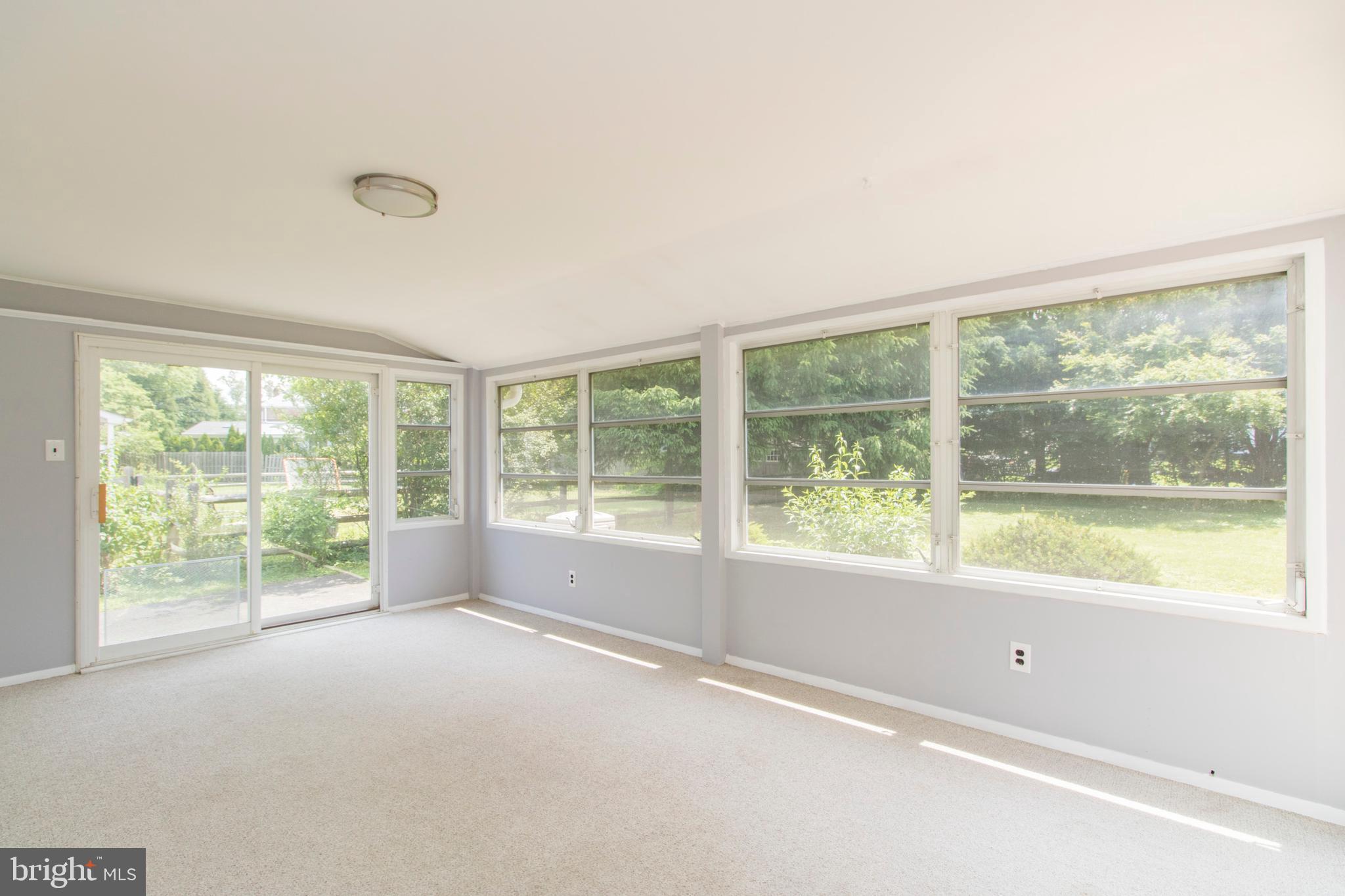 406 Burton Road Oreland, PA 19075 - Photo 18 of 44 Enclosed porch with slider to side yard