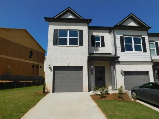 a front view of a house with a yard