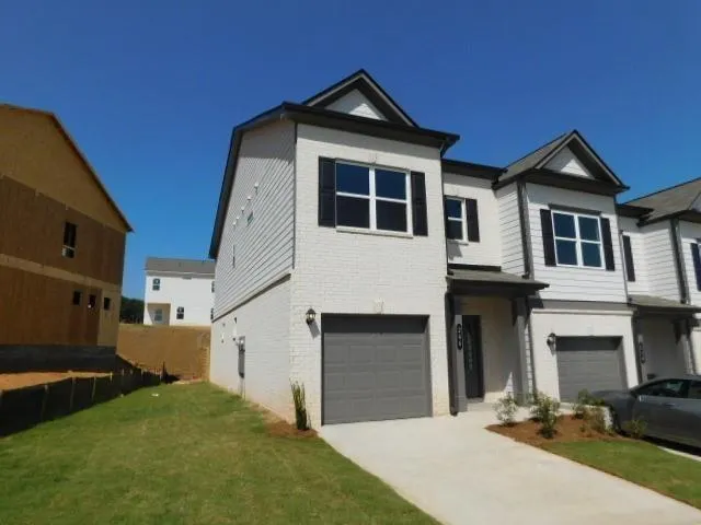 a front view of a house with a yard