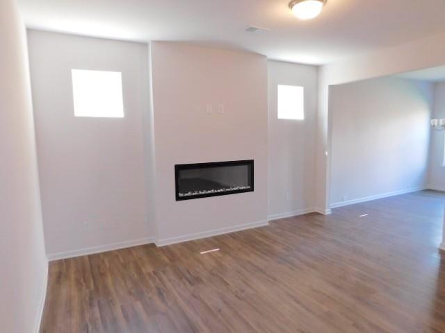 246 Dupont Drive Cartersville, GA 30121 - Photo 6 of 28 a view of an empty room with wooden floor and a window