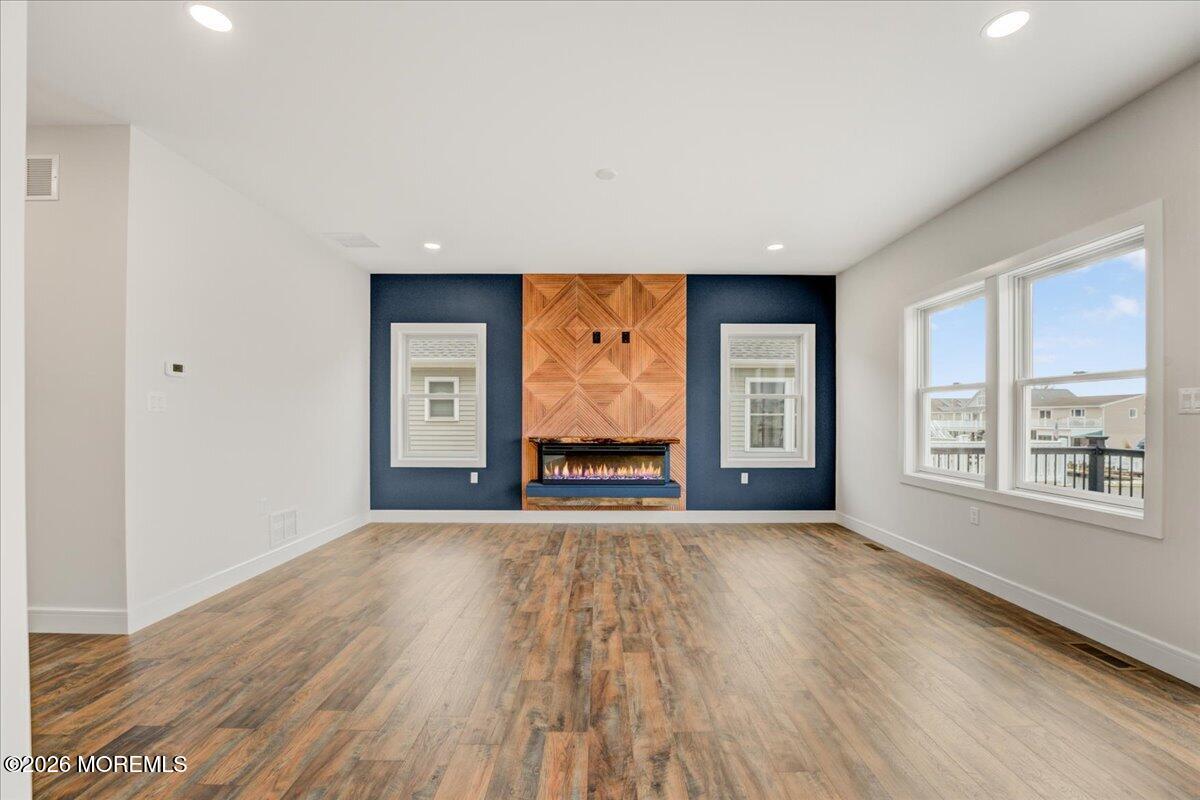 16 West Raritan Drive Little Egg Harbor, NJ 08087 - Photo 20 of 53 a view of an empty room with wooden floor and a window