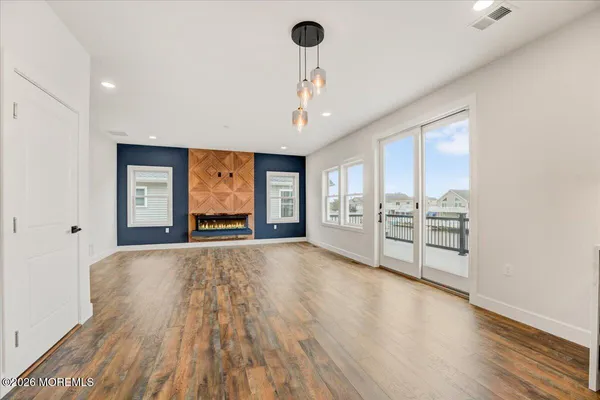 a large kitchen with cabinets a sink and wooden floor