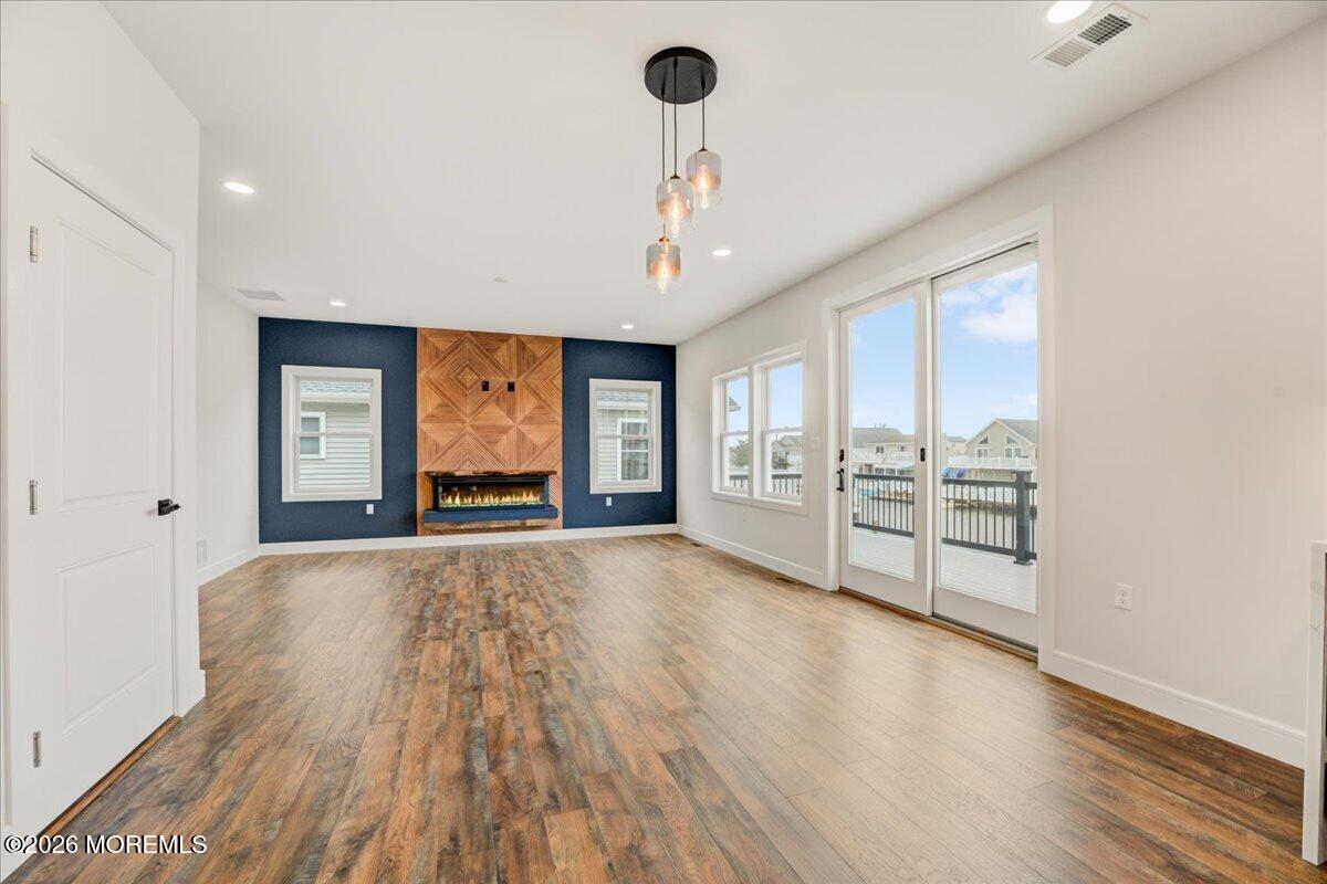 16 West Raritan Drive Little Egg Harbor, NJ 08087 - Photo 23 of 53 a view of an empty room with a window and wooden floor
