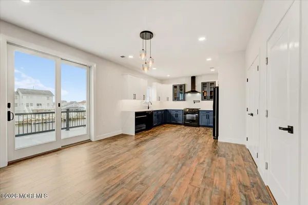a kitchen with stainless steel appliances granite countertop a stove refrigerator and cabinets