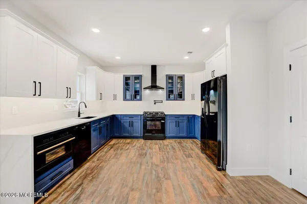 a large bathroom with a tub sink and mirror