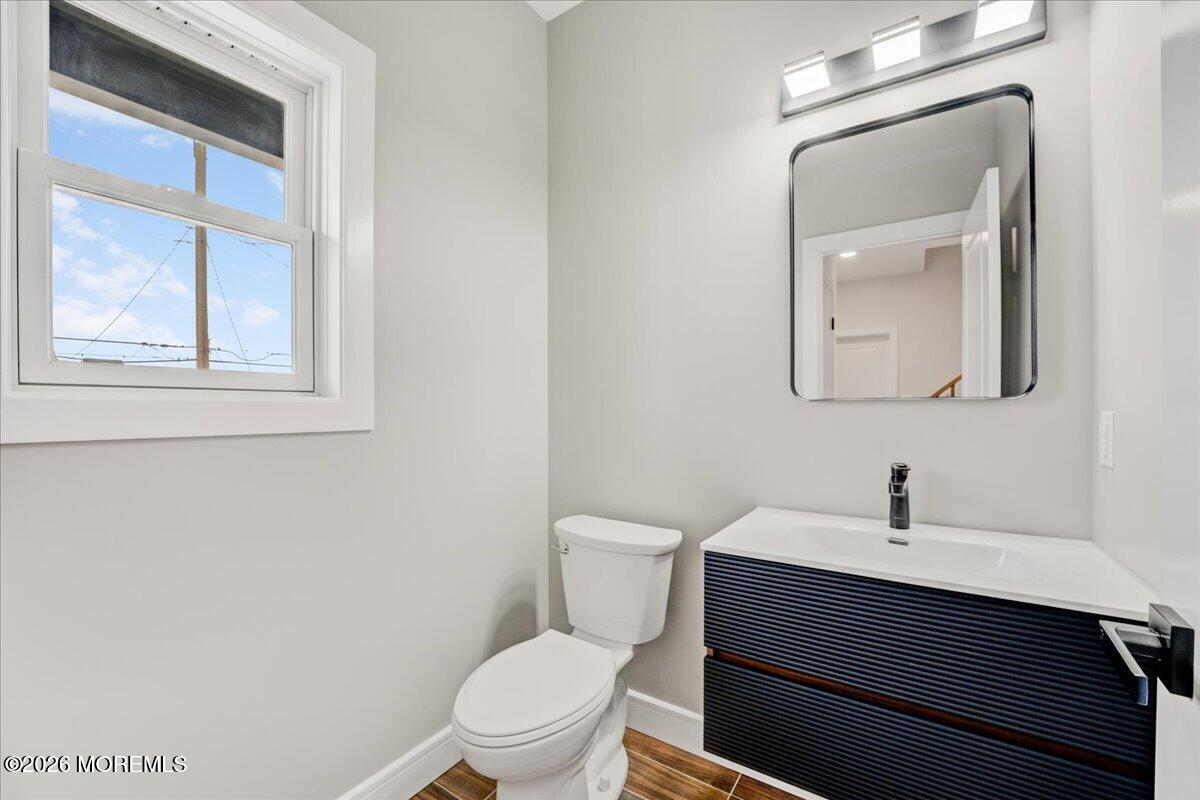 16 West Raritan Drive Little Egg Harbor, NJ 08087 - Photo 30 of 53 a bathroom with a toilet a sink and mirror