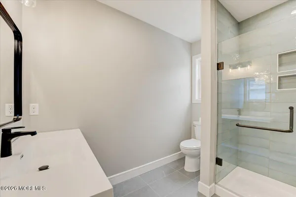 a bathroom with a toilet and a shower