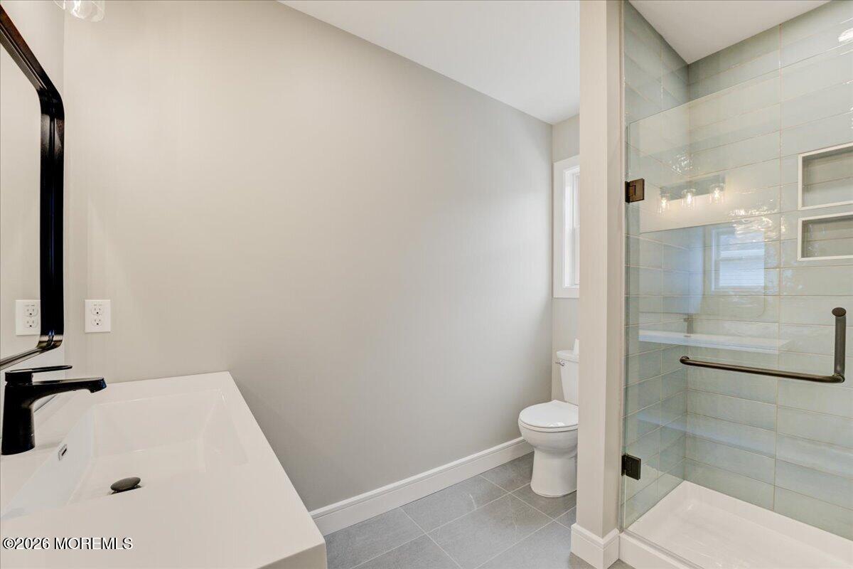 16 West Raritan Drive Little Egg Harbor, NJ 08087 - Photo 34 of 53 a bathroom with a sink a toilet and shower