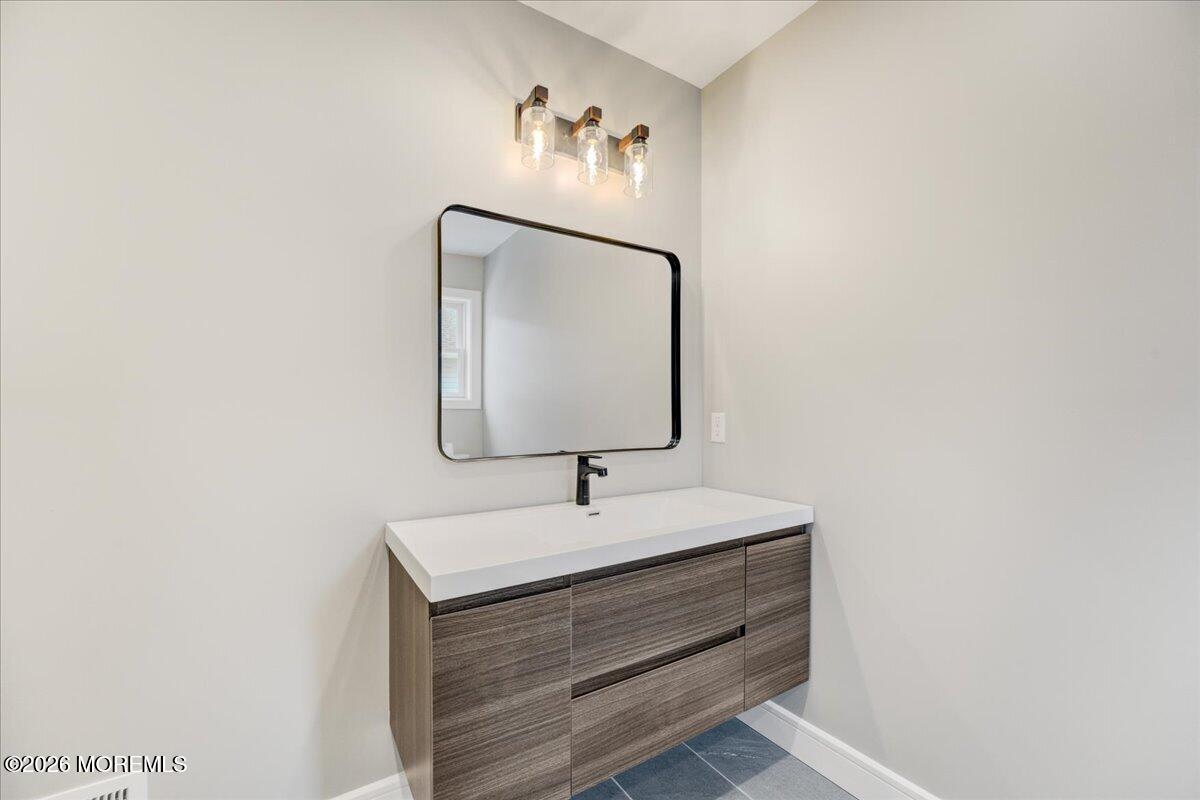 16 West Raritan Drive Little Egg Harbor, NJ 08087 - Photo 35 of 53 a bathroom with a sink and a mirror