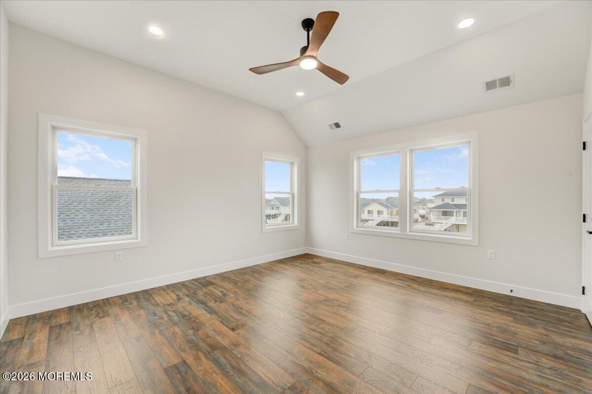 16 West Raritan Drive Little Egg Harbor, NJ 08087 - Photo 38 of 53 a view of an empty room with a window and wooden floor
