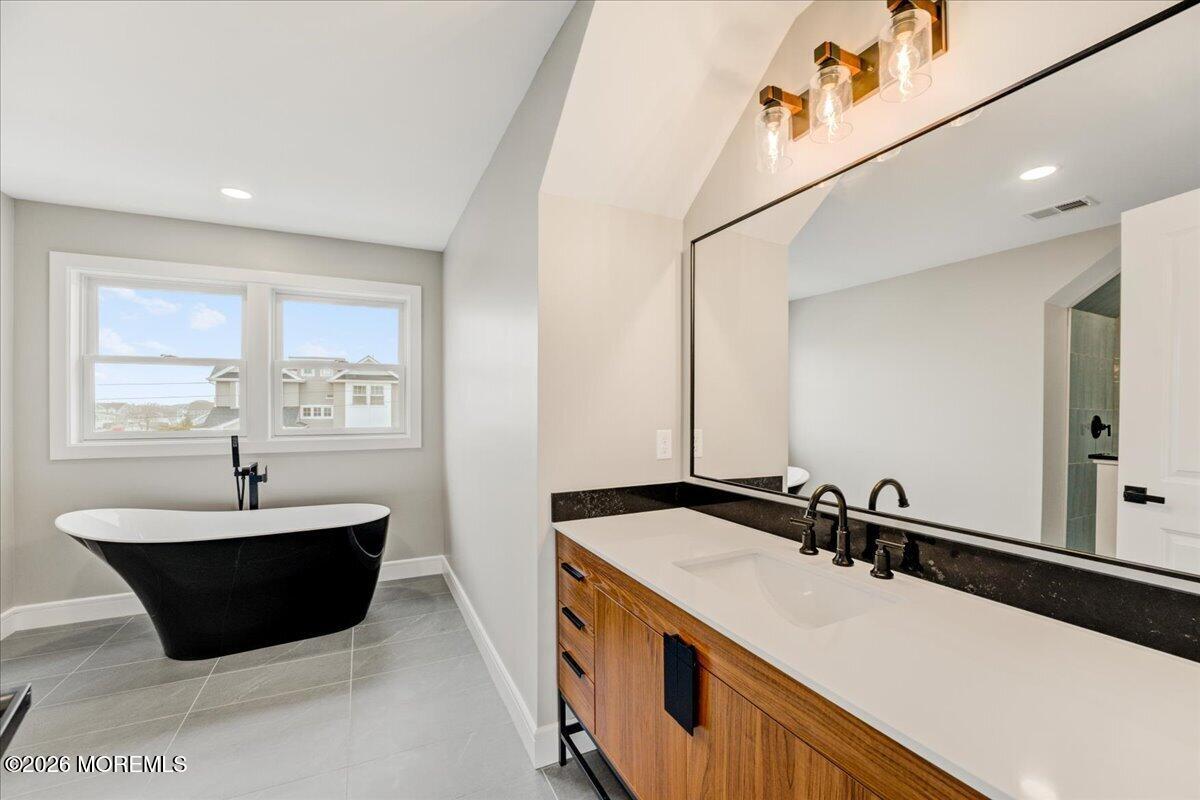 16 West Raritan Drive Little Egg Harbor, NJ 08087 - Photo 41 of 53 a spacious bathroom with a bathtub and a sink
