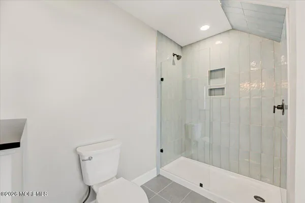 a bathroom with a sink toilet and a mirror