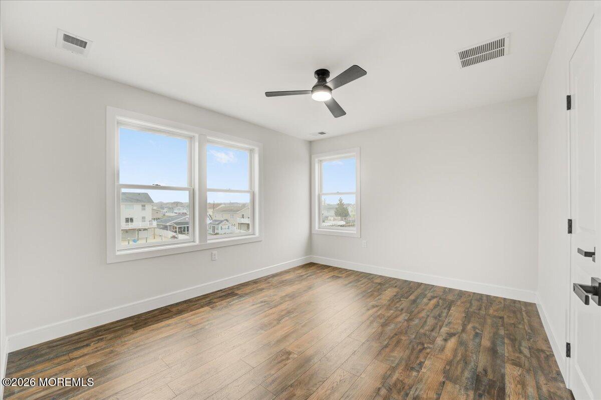 16 West Raritan Drive Little Egg Harbor, NJ 08087 - Photo 46 of 53 a view of an empty room with wooden floor and a window
