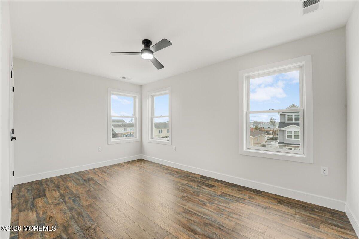 16 West Raritan Drive Little Egg Harbor, NJ 08087 - Photo 47 of 53 a view of an empty room with a window and wooden floor