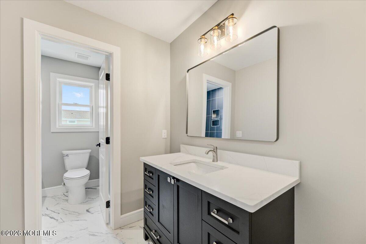 16 West Raritan Drive Little Egg Harbor, NJ 08087 - Photo 48 of 53 a bathroom with a sink toilet and a mirror