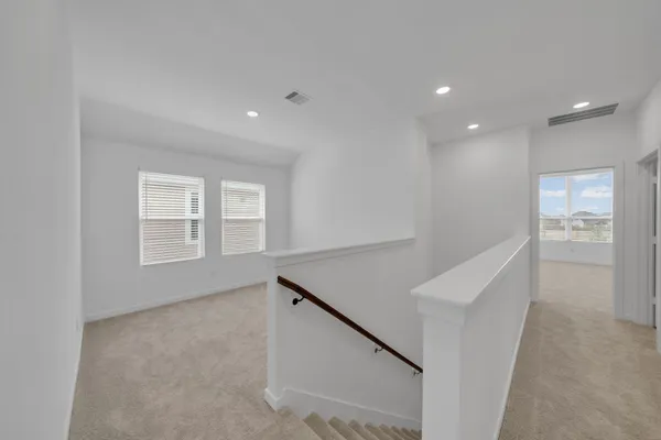 a view of an empty room with windows