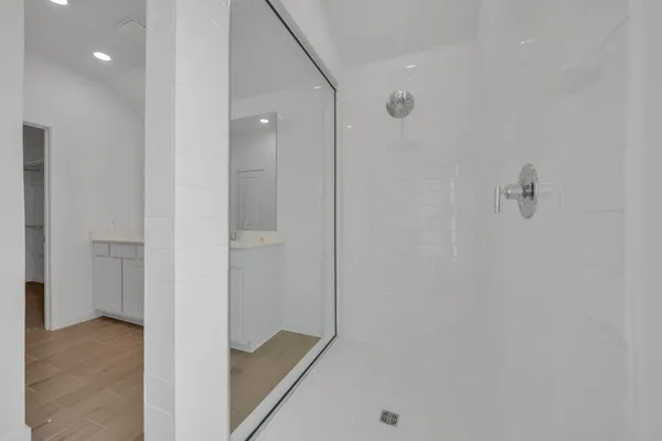 a view of a hallway with wooden floor