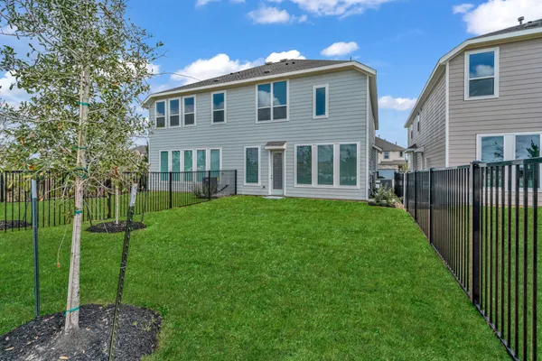 a front view of a house with a garden and yard