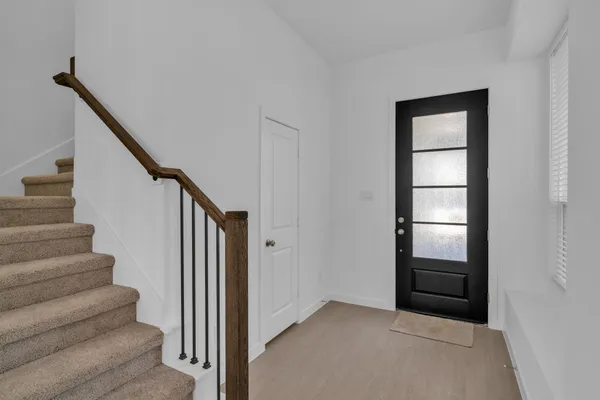 a view of entryway and hall with wooden floor
