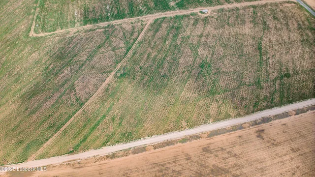 a view of a field with an ocean view