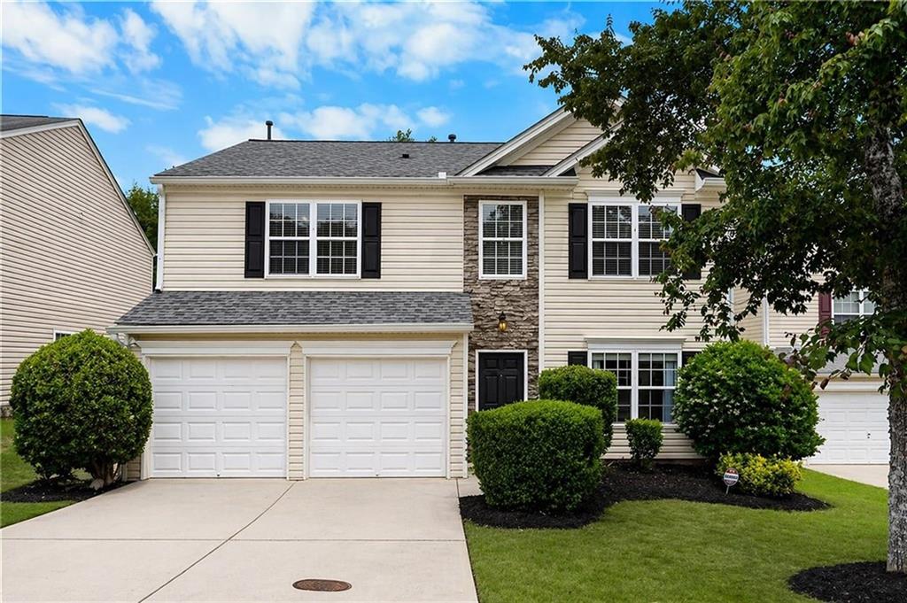 a front view of a house with a yard