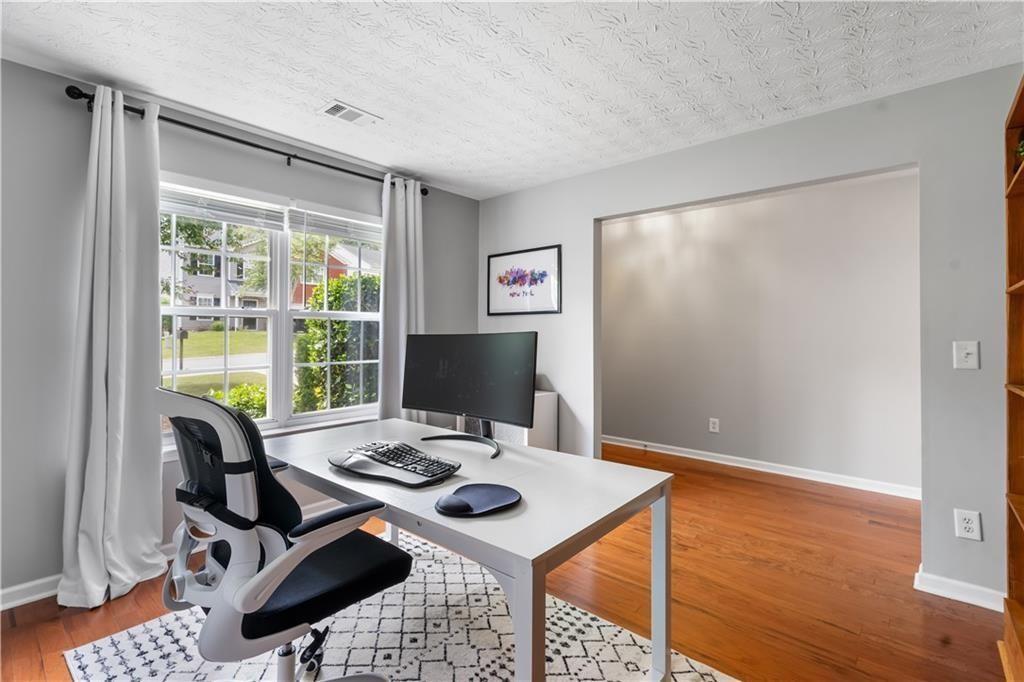 411 Sugar Maple Court Canton, GA 30114 - Photo 12 of 34 a view of a workspace with furniture and a window