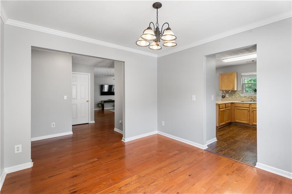 411 Sugar Maple Court Canton, GA 30114 - Photo 15 of 34 a view of a hallway with wooden floor and a kitchen