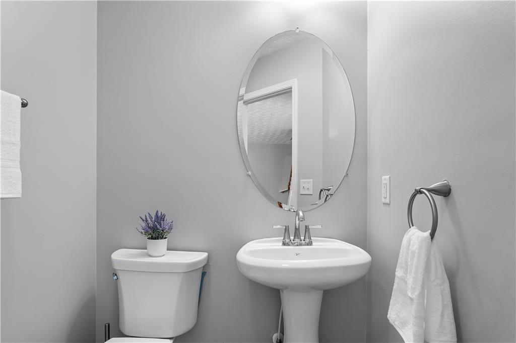 411 Sugar Maple Court Canton, GA 30114 - Photo 16 of 34 a bathroom with a toilet sink and mirror