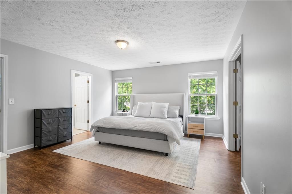 411 Sugar Maple Court Canton, GA 30114 - Photo 18 of 34 a spacious bedroom with a bed and a window